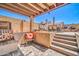 Inviting outdoor patio area with a seating area, stairs, and a stone-texture privacy fence at 16805 S 29Th Pl, Phoenix, AZ 85048