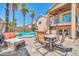 Outdoor patio with an umbrella-covered dining table, lounge chair and views of the swimming pool at 16805 S 29Th Pl, Phoenix, AZ 85048