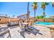 Outdoor living space with dining table, lounge seating, and built-in BBQ area at 16805 S 29Th Pl, Phoenix, AZ 85048