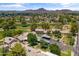 An aerial view of a well-maintained community with lush greenery, carport parking, and mountain views at 18206 N 45Th Ave, Glendale, AZ 85308