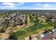An elevated view of a golf course community with pools, tree-lined streets, and scenic greenways at 18206 N 45Th Ave, Glendale, AZ 85308