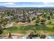 Bird's-eye view of a neighborhood bordering a golf course, complete with mature trees and swimming pools at 18206 N 45Th Ave, Glendale, AZ 85308