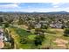 A scenic aerial view of a golf course community featuring lush green fairways and neighborhood pools at 18206 N 45Th Ave, Glendale, AZ 85308