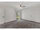 Bright bedroom features neutral carpet, a fan, a sliding glass door to outside at 18206 N 45Th Ave, Glendale, AZ 85308