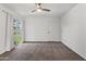 Bedroom boasts neutral carpet, a fan, and a sliding glass door with view of lawn at 18206 N 45Th Ave, Glendale, AZ 85308