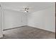 Spacious bedroom with neutral carpet, a ceiling fan, and a closet at 18206 N 45Th Ave, Glendale, AZ 85308