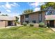Inviting townhouse with green lawn, shrubs, and sidewalk under a partly cloudy sky at 18206 N 45Th Ave, Glendale, AZ 85308