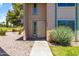 Inviting townhouse entrance, close up, with sidewalk, rock garden, and green shrubbery at 18206 N 45Th Ave, Glendale, AZ 85308