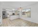 Bright kitchen with granite counters, stainless steel refrigerator, and tile floors at 18206 N 45Th Ave, Glendale, AZ 85308