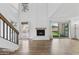 Bright living room with fireplace, wood-look flooring, and high ceilings at 18206 N 45Th Ave, Glendale, AZ 85308