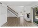 Bright living room with staircase, light walls, fireplace, and wood-look flooring at 18206 N 45Th Ave, Glendale, AZ 85308