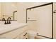 Bathroom featuring white vanity, black fixtures, and walk in shower with glass door at 1903 E Empeltre Rd, San Tan Valley, AZ 85140