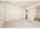 Large bedroom with neutral walls and carpet, multiple doorways, and abundant natural light at 1903 E Empeltre Rd, San Tan Valley, AZ 85140