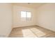 Bedroom with wood-look tile flooring and neutral walls with natural light from large windows at 1903 E Empeltre Rd, San Tan Valley, AZ 85140