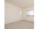 Carpeted bedroom with natural light from windows, neutral walls, and ample space at 1903 E Empeltre Rd, San Tan Valley, AZ 85140