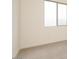 Bright bedroom featuring neutral carpeting, off white walls and a large window for natural light at 1903 E Empeltre Rd, San Tan Valley, AZ 85140
