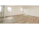 Open bedroom with wood floors and sliding glass doors that lead to the backyard at 1903 E Empeltre Rd, San Tan Valley, AZ 85140