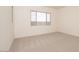 Bright bedroom with a large window and neutral carpet offers a serene space at 1903 E Empeltre Rd, San Tan Valley, AZ 85140