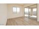 Empty bedroom with wood floors, sliding glass doors, and large windows at 1903 E Empeltre Rd, San Tan Valley, AZ 85140