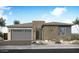 Modern single-story home with a two-car garage, desert landscaping, and a neutral color palette at 1903 E Empeltre Rd, San Tan Valley, AZ 85140