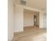 Well-lit hallway features wood-look tile flooring, neutral walls, and recessed lighting at 1903 E Empeltre Rd, San Tan Valley, AZ 85140