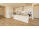 Spacious kitchen with white cabinets, stainless steel appliances, and a large island at 1903 E Empeltre Rd, San Tan Valley, AZ 85140