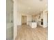 Open-concept kitchen features white cabinets, a center island, and wood-look tile flooring at 1903 E Empeltre Rd, San Tan Valley, AZ 85140