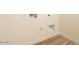 Laundry hookups feature tile floors and neutral colored walls, ready for appliance installation at 1903 E Empeltre Rd, San Tan Valley, AZ 85140