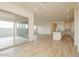 Open concept living room with wood floors, recessed lighting, kitchen, and sliding doors at 1903 E Empeltre Rd, San Tan Valley, AZ 85140