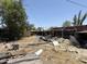 Untidy backyard filled with debris, exposed roofing, and building materials at 2030 N 21St Pl, Phoenix, AZ 85006