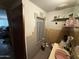 Outdated bathroom with pink sink and brown tile, presenting a renovation opportunity to create a modern space at 2030 N 21St Pl, Phoenix, AZ 85006