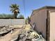 Exterior home featuring a concrete block fence on the left and building refuse piled in the foreground at 2030 N 21St Pl, Phoenix, AZ 85006