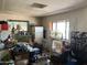 A cluttered living room featuring hardwood floors, a window, and textured walls and ceiling at 2030 N 21St Pl, Phoenix, AZ 85006