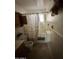 Modest bathroom with a shower-tub combination, vintage fixtures and neutral-colored tile at 2102 W Hazelwood St, Phoenix, AZ 85015