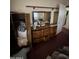 Bedroom with a vintage dresser with mirror, closet and door into a hallway at 2102 W Hazelwood St, Phoenix, AZ 85015