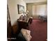 Bedroom with red carpet, a window with blinds and curtains, and a painting hanging on the wall at 2102 W Hazelwood St, Phoenix, AZ 85015