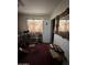 Bedroom with vintage mirror, desk, chair, curtains, and access door at 2102 W Hazelwood St, Phoenix, AZ 85015