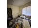 Bedroom featuring natural light with a window, bed, closet, and side table with lamp at 2102 W Hazelwood St, Phoenix, AZ 85015