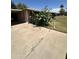 The exterior of the home has mature landscaping and an extended carport in front of the house at 2102 W Hazelwood St, Phoenix, AZ 85015