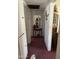 Hallway featuring red carpet, a mirror and small table with a decorative arrangement at 2102 W Hazelwood St, Phoenix, AZ 85015