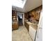 A rustic kitchen with wooden cabinets, brick backsplash, and modern appliances at 2102 W Hazelwood St, Phoenix, AZ 85015