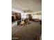 Spacious living room with vintage decor including brick fireplace, built-in cabinet, and plush seating at 2102 W Hazelwood St, Phoenix, AZ 85015