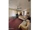 Spacious primary bedroom featuring red carpet and natural light from the windows at 2102 W Hazelwood St, Phoenix, AZ 85015