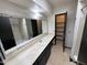 Bathroom vanity features a large mirror, storage, and tile floors at 220 S Old Litchfield Rd # 104, Litchfield Park, AZ 85340