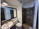 Modern bathroom with a tiled shower, vanity, and toilet, designed for comfort and convenience at 220 S Old Litchfield Rd # 104, Litchfield Park, AZ 85340