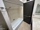 Compact bathroom with a shower and bath combination and ceramic tile at 220 S Old Litchfield Rd # 104, Litchfield Park, AZ 85340