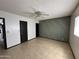 Spacious bedroom features neutral paint, tile floors, and a ceiling fan at 220 S Old Litchfield Rd # 104, Litchfield Park, AZ 85340