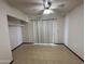 Neutral bedroom with tile floors, bright windows, and ceiling fan at 220 S Old Litchfield Rd # 104, Litchfield Park, AZ 85340