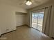 Bright bedroom with balcony access, tile floors, and closet at 220 S Old Litchfield Rd # 104, Litchfield Park, AZ 85340