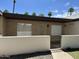 Charming single-story home with a brick facade, white fencing, and well-maintained landscaping at 220 S Old Litchfield Rd # 104, Litchfield Park, AZ 85340